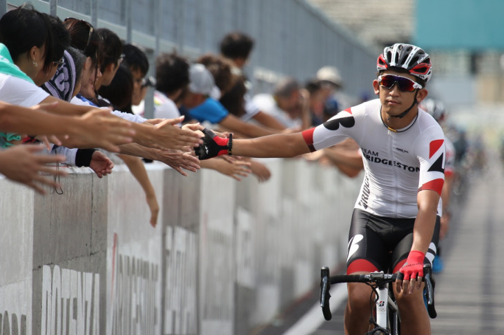 ピットウォール沿いに観客とハイタッチしつつ入場 シマノ鈴鹿ロードレースクラシックの恒例イベントだ